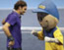 Roger Federer jokes with a mascot in an exhibition match in Brazil