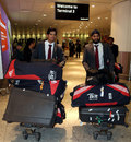 Alastair Cook and Monty Panesar walk through Heathrow Airport