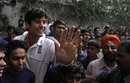 England's captain Alastair Cook poses for a photograph with children during the team's visit to Future Hope in Kolkata, India, December 1, 2012