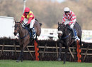 Puffin Billy, ridden by Barry Geraghty, jumps upsides Up To Something 