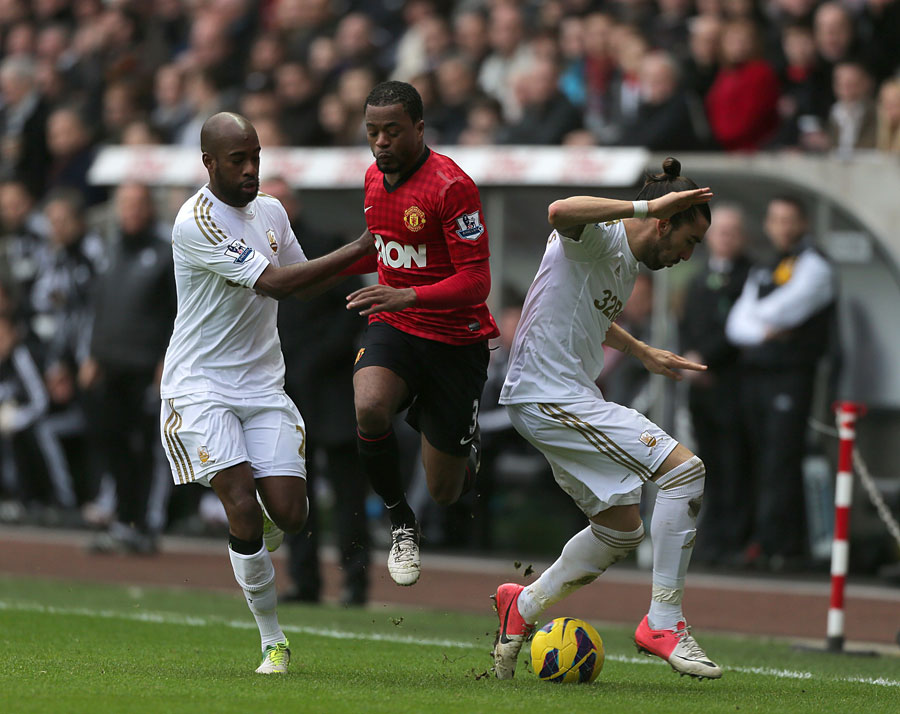 Patrice Evra battles for the ball with Swansea City