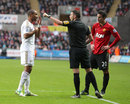 Ashley Williams remonstrates with referee Mike Oliver as Robin van Persie looks on