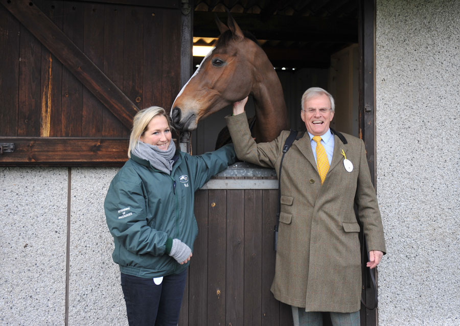 Laura Collett and Clive Smith stand beside Kauto Star