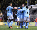 Manchester City players celebrate Edin Dzeko's goal