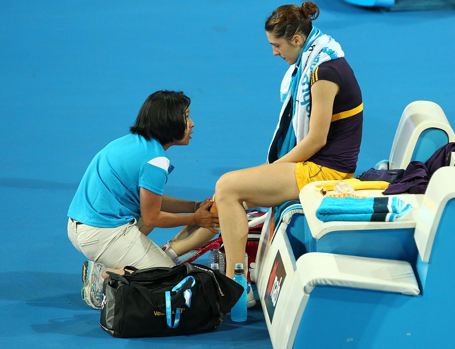 Andrea Petkovic is treated for a knee injury