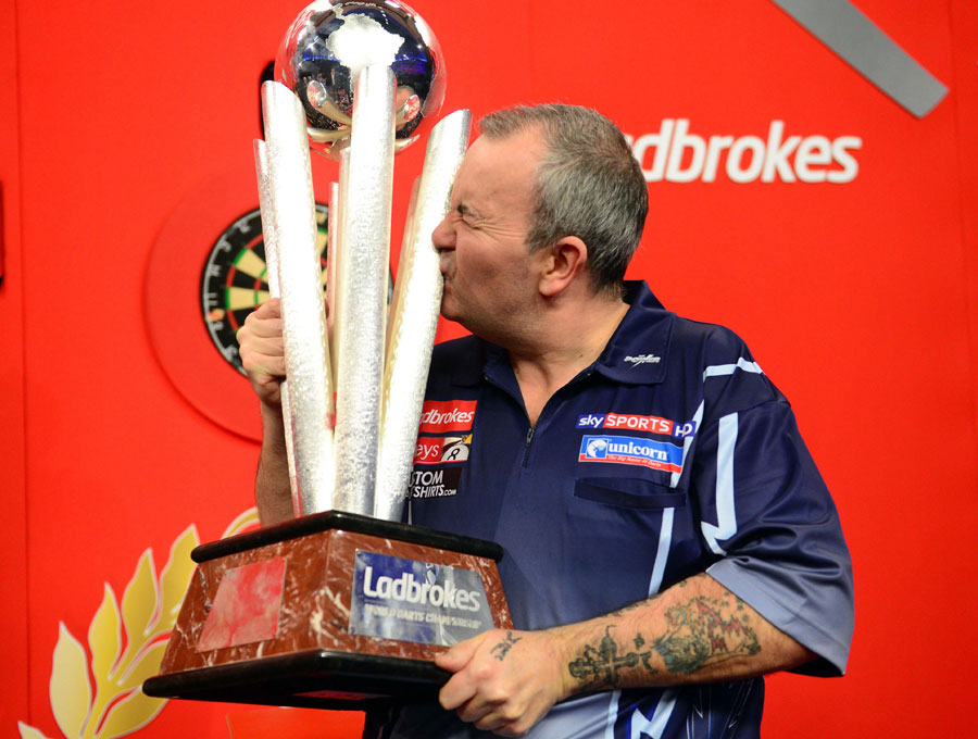 Phil Taylor gives the trophy a firm kiss