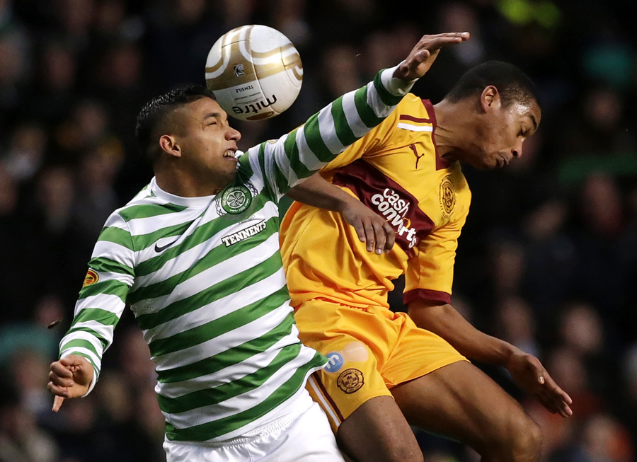 Celtic's Emilio Izaguirre and Motherwell's Chris Humphrey fight for the ball