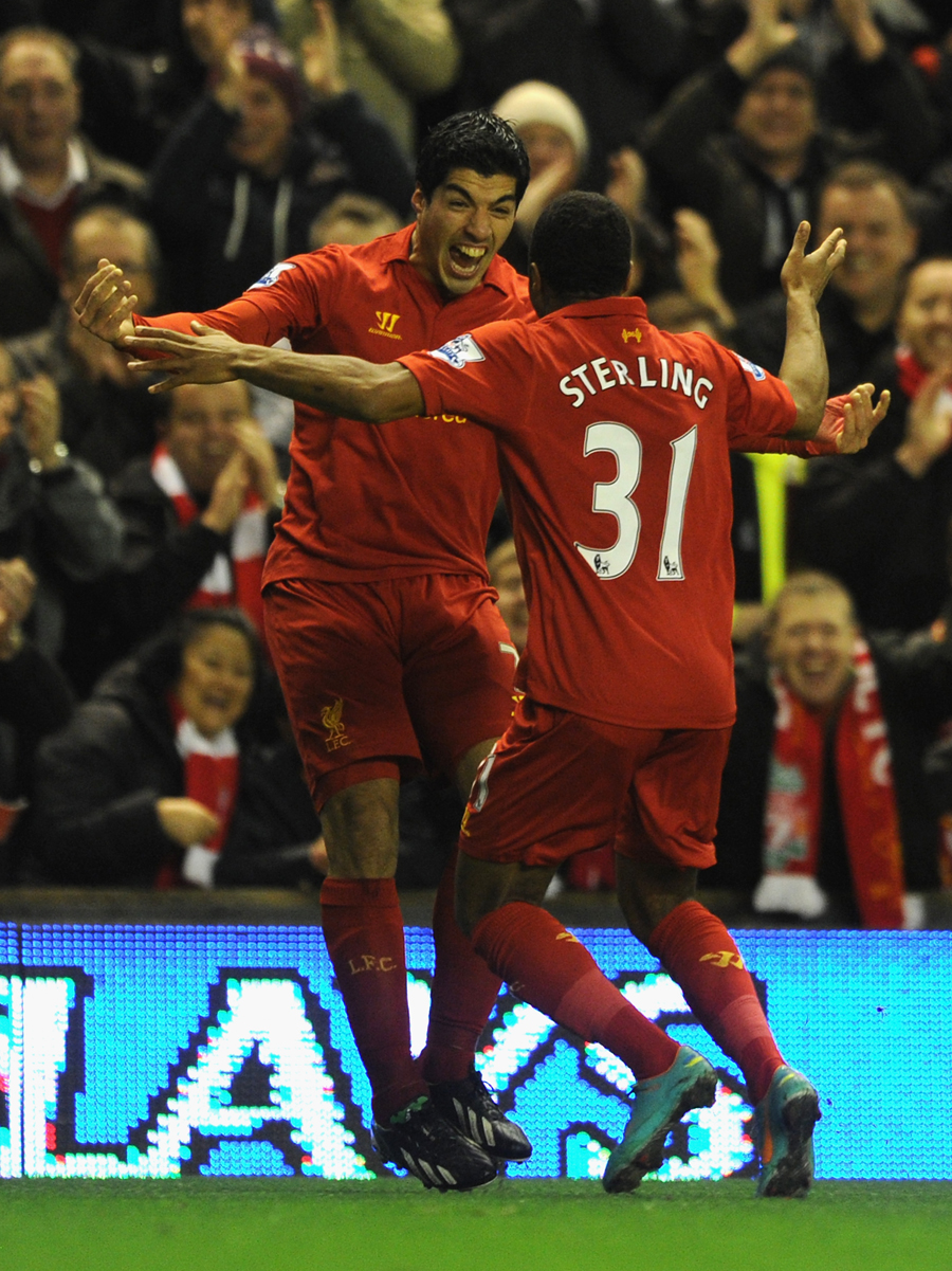 Luis Suarez celebrates with Raheem Sterling