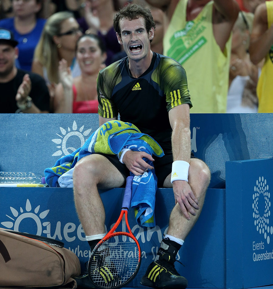 Andy Murray sits down clutching his calf
