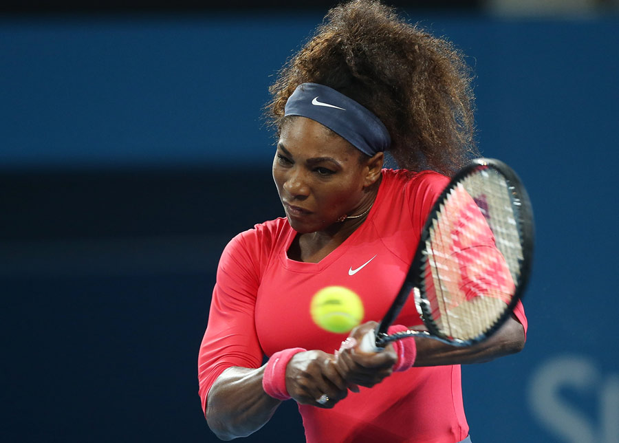 Serena Williams climbs into a backhand