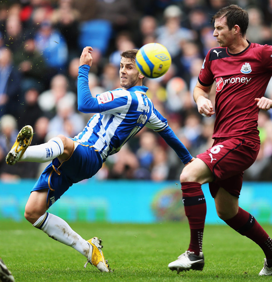 Andrea Orlandi flicks the ball home as Mike Williamson looks on