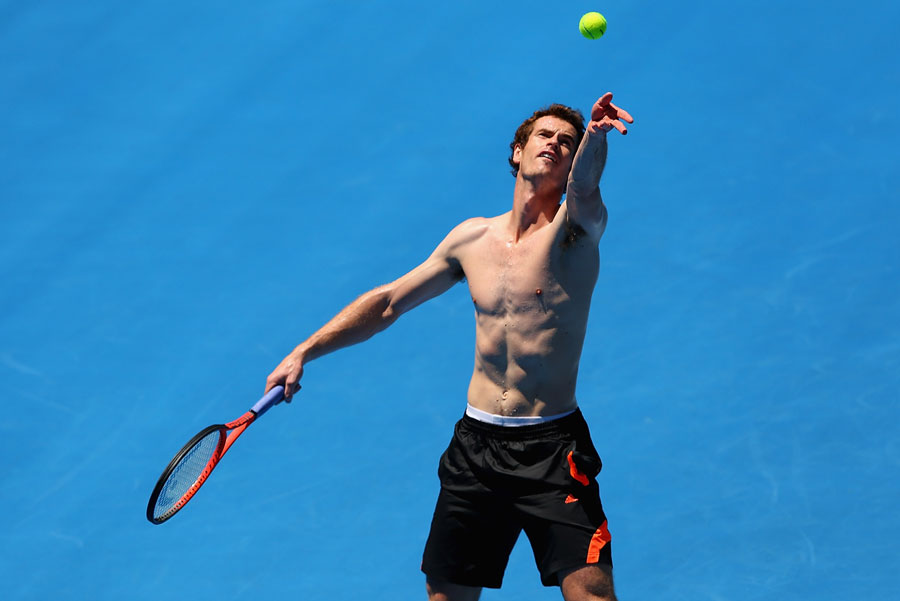 Andy Murray serves during a training session