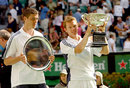 Thomas Johansson and Marat Safin hold their trophies for crowd
