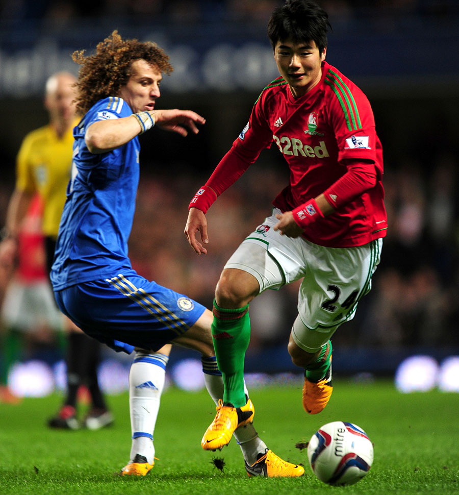 David Luiz and Sung-Yeung Ki battle for the ball