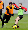 Luis Suarez takes on Jon Flanagan during a Liverpool training session