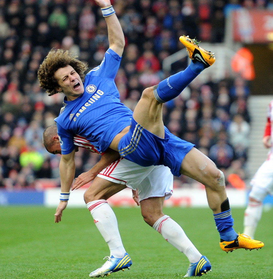 David Luiz is challenged by Jonathan Walters