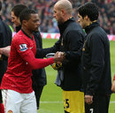 Patrice Evra shakes hands with Luis Suarez