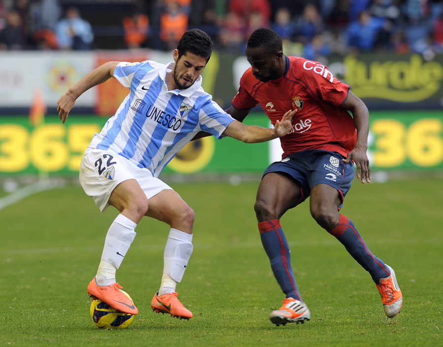 Isco twists away from Roland Lamah