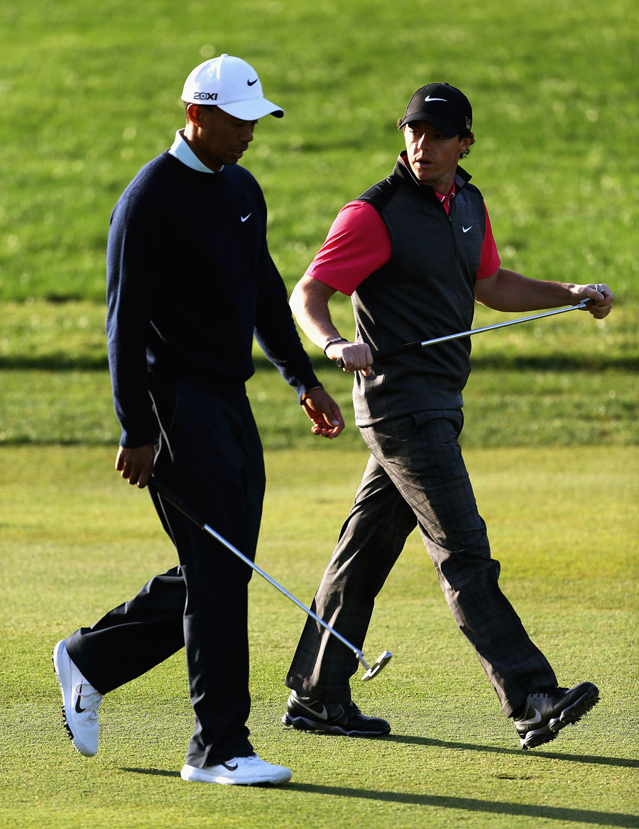 Tiger Woods and Rory McIlroy walk down the 10th fairway