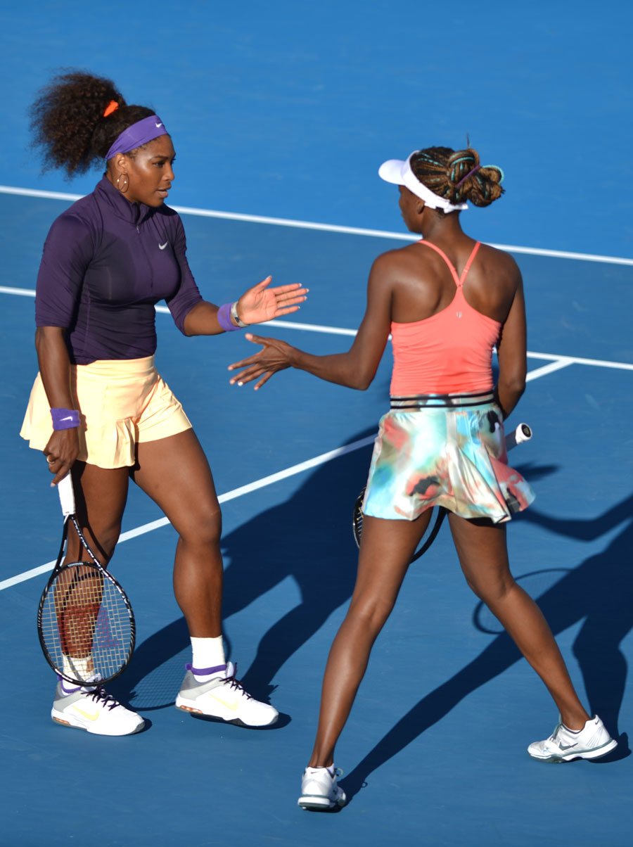 Serena Williams speaks with her sister Venus during their women's doubles match against Vera Dushevina and Olga Govortsova of Balaruson