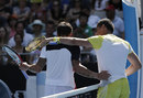 Janko Tipsarevic is helped off court by Nicolas Almagro