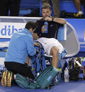 Stanislas Wawrinka receives treatment from the trainer