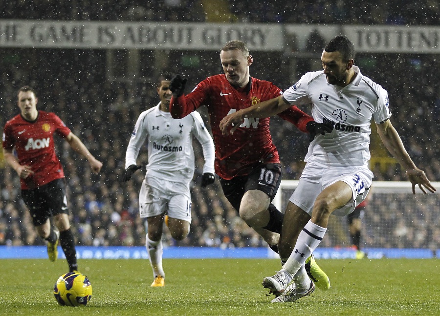 Wayne Rooney is tackled in the area by Steven Caulker