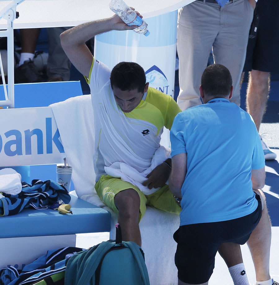 Nicolas Almagro throws a water bottle while receiving treatment 