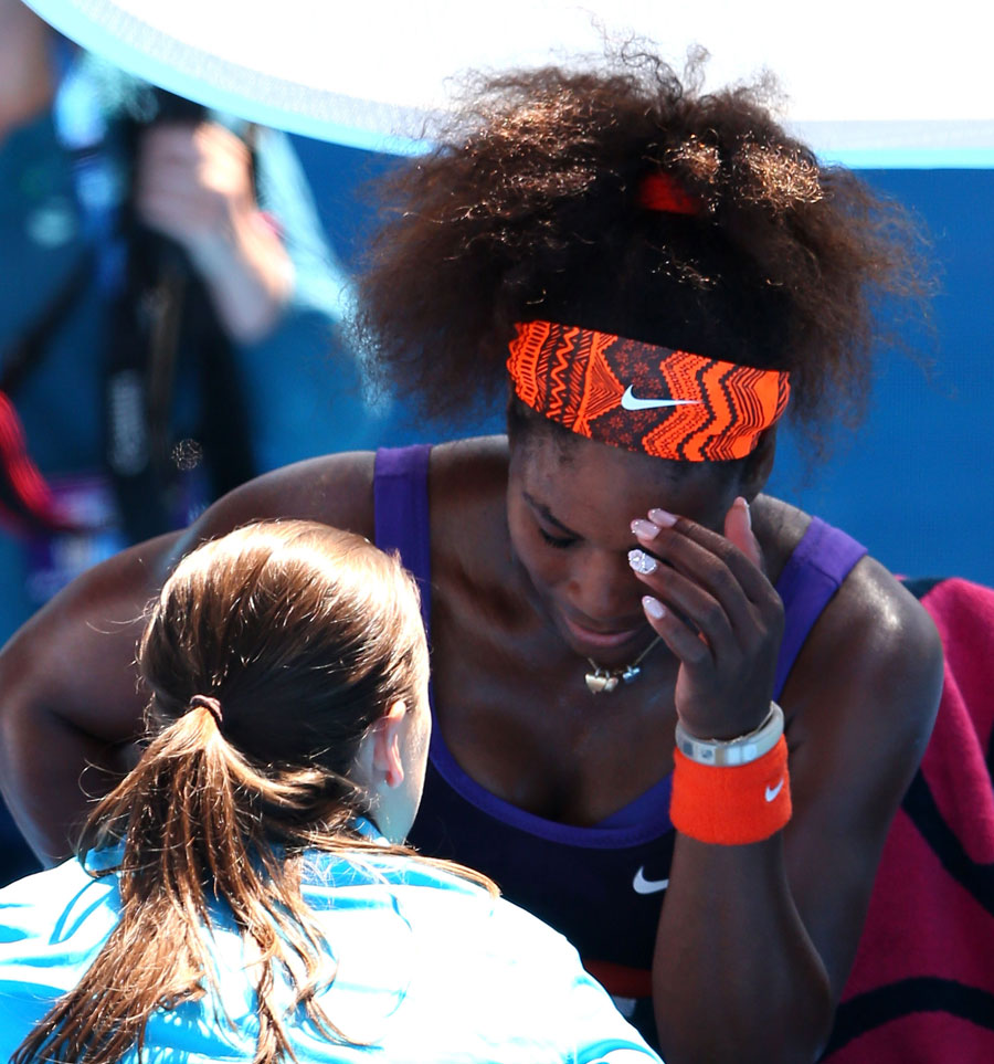 Serena Williams talks to the trainer