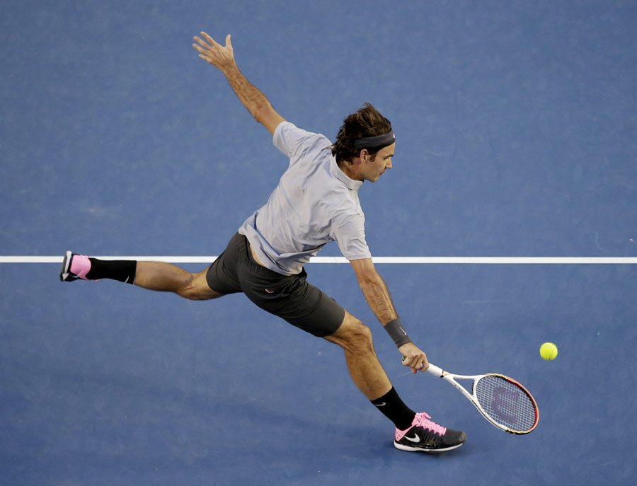 Roger Federer stoops for a volley