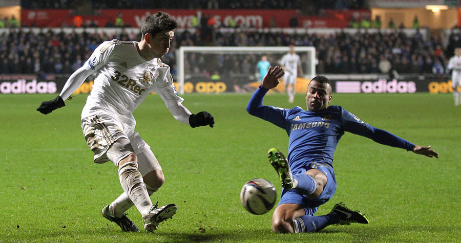 Ashley Cole and Pablo Hernandez battle for the ball