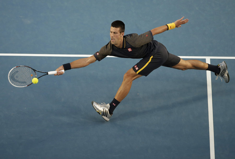 Novak Djokovic stretches for a volley