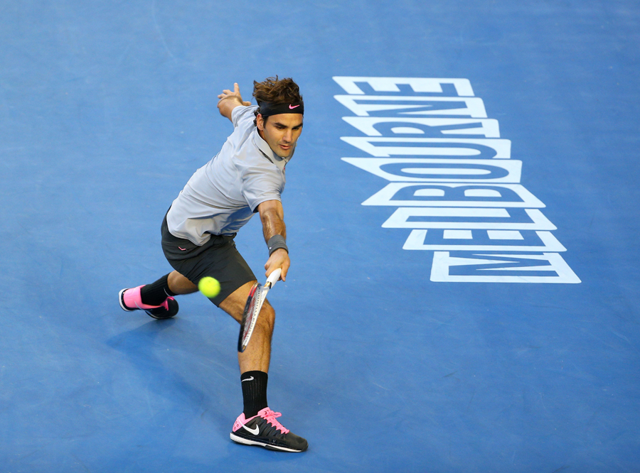 Roger Federer stretches for a return