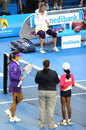 Victoria Azarenka sits on her chair as Li Na waits for the coin toss