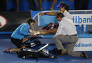 Li Na receives treatment for an ankle injury