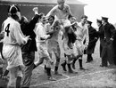 England captain Eric Evans, top, is chaired off by his jubilant team-mates