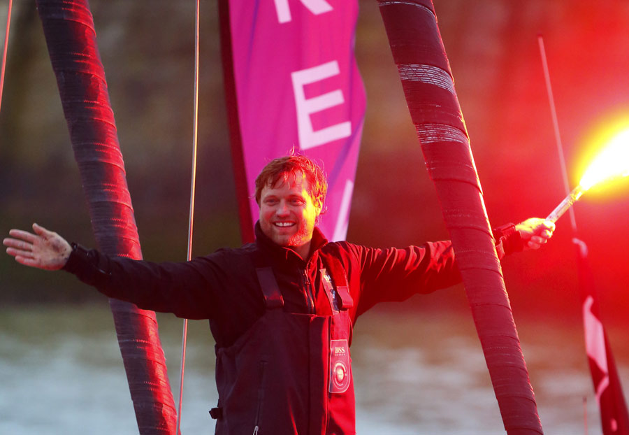 Alex Thomson celebrates after finishing third in the Vendee Globe Yacht Race