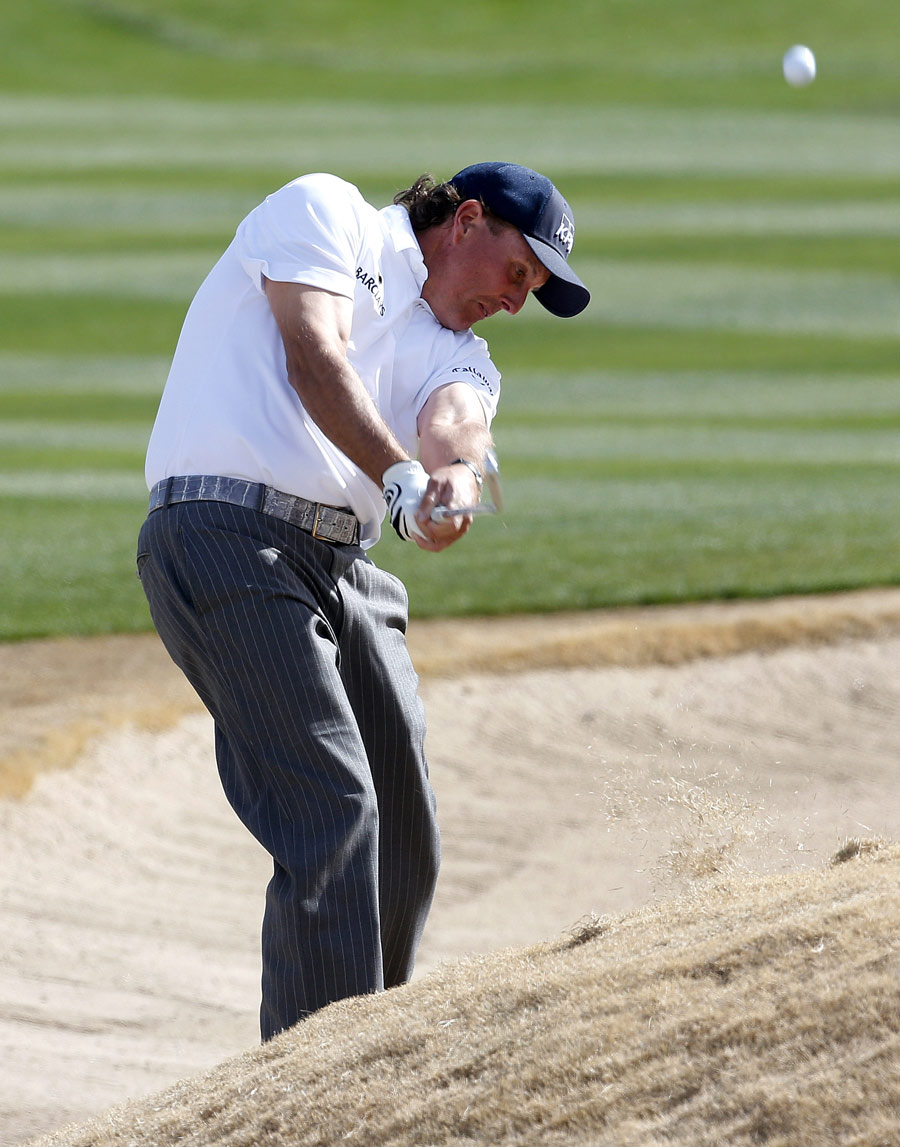 Phil Mickelson plays from an awkward lie