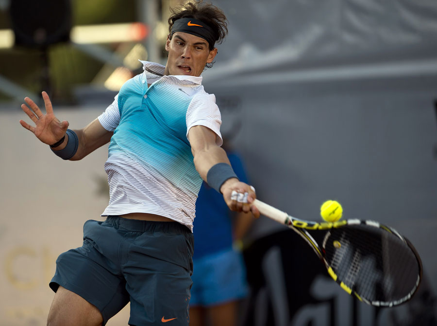 Rafael Nadal hits a return in a doubles match
