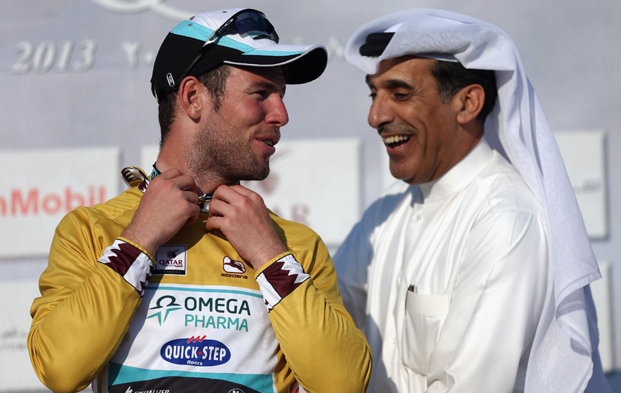 Mark Cavendish pulls on the race leaders gold jersey