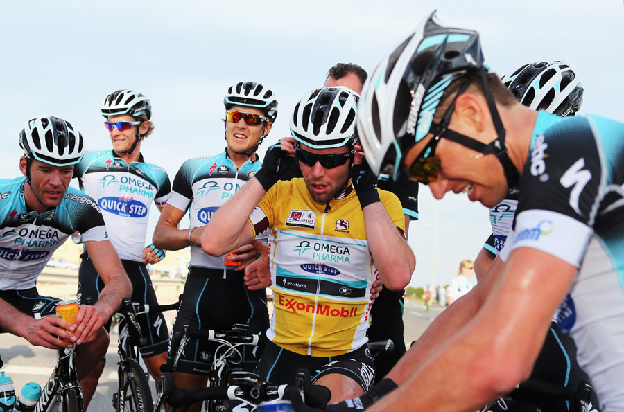 Mark Cavendish recovers with his team after winning stage five