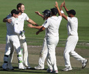 Daniel Vettori is surrounded after removing Mitchell Johnson
