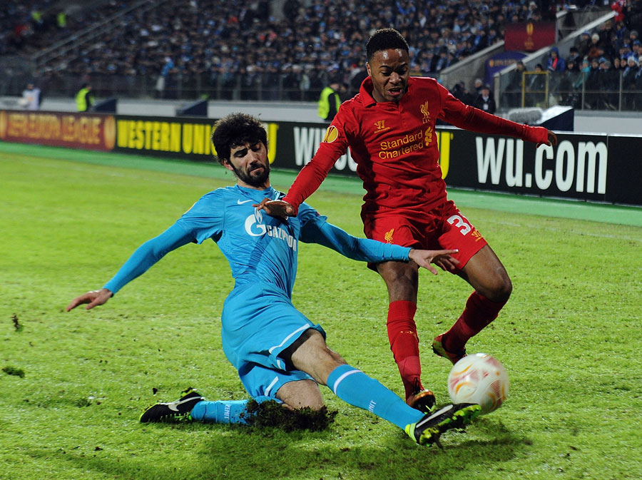 Raheem Sterling competes with Luis Neto for the ball