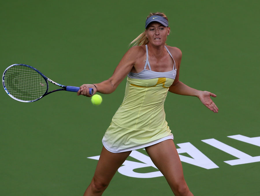 Maria Sharapova hits a return to Samantha Stosur