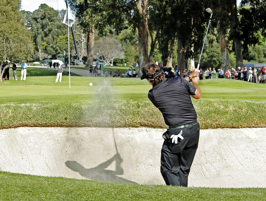Phil Mickelson splashes out of a bunker