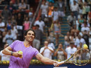 Rafael Nadal sends a ball to fans after defeating Martin Alund