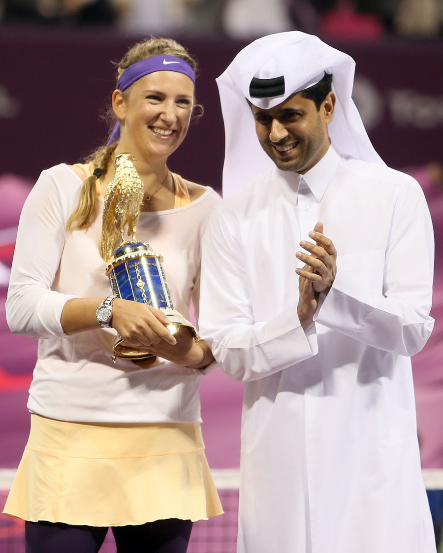 Victoria Azarenka poses with the trophy along side the president of the Qatar Tennis Federation