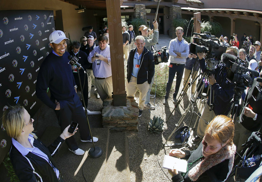 Tiger Woods talks to the media