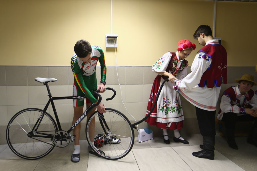 Cyclists from the Belarus team alongside performers for the opening ceremony