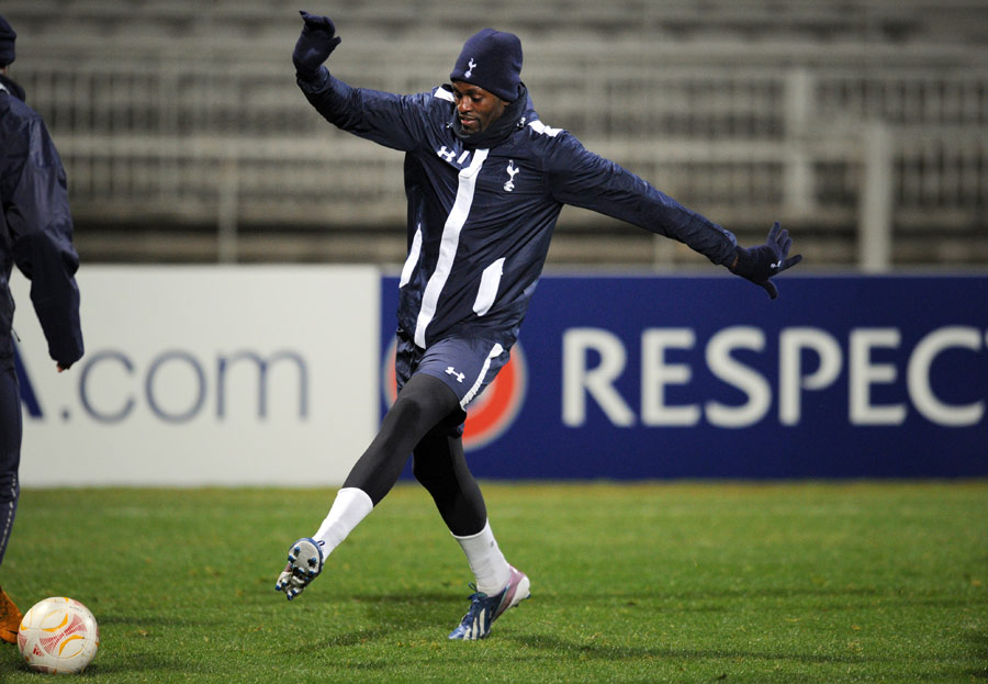 Emmanuel Adebayor passes a ball during a Tottenham training session